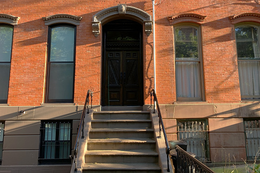 A classic brownstone entrance in Hoboken, New Jersey, USA, featuring a charming facade with a staircase leading to the front door.