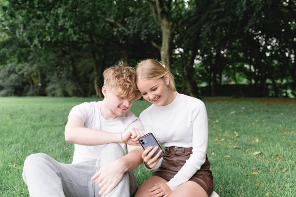 istock Young teen couple with Mobile 1718606551