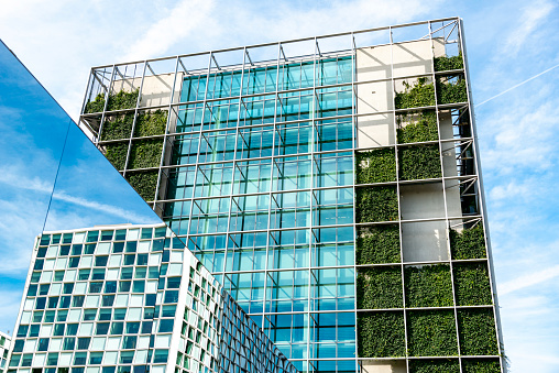 Sustainable building, modern architecture with mirrors and green walls. Low angle shot, The Netherlands