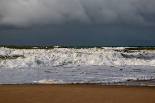 istock Empty wild sandy beach, Atlantic Ocean seascape, sea waves, beautiful cloudscape, dramatic landscape, travel content, Lisbon, Portugal 1718619877