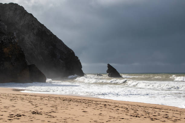 istock Empty wild sandy beach, Atlantic Ocean seascape, sea waves, beautiful cloudscape, dramatic landscape, travel content, Lisbon, Portugal 1718621509
