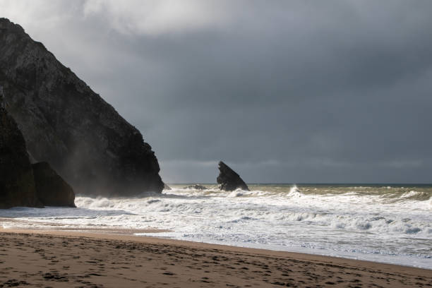 istock Empty wild sandy beach, Atlantic Ocean seascape, sea waves, beautiful cloudscape, dramatic landscape, travel content, Lisbon, Portugal 1718622153