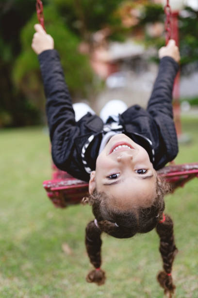 istock Beautiful girl swinging on play ground swing 1718627749