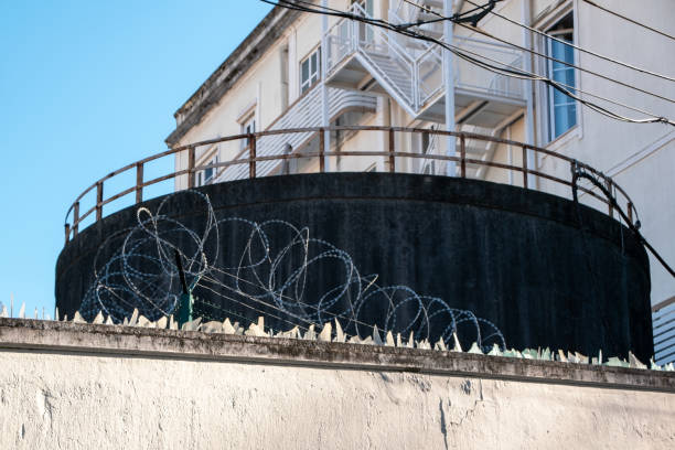 istock Barbed wire and broken glass keep birds away, security fence 1718629469