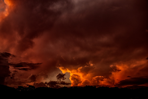 Clouds after a storm mixed with sunlight at sunset with orange and pink colours, in Sierra de la ventana, one of the few mountain-sites of Buenos Aires Province, in central Argentina