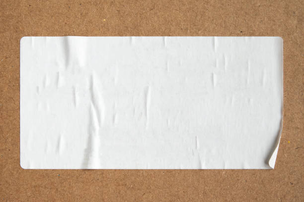 istock Blank white paper sticker texture on brown cardboard background 1718641518