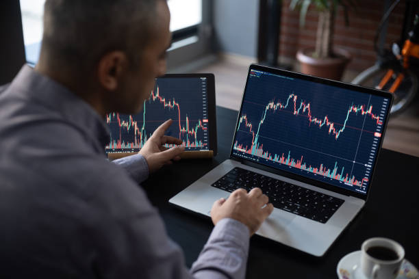 Man Checking His Stock Market Exchange Investment Using His Laptop Computer.