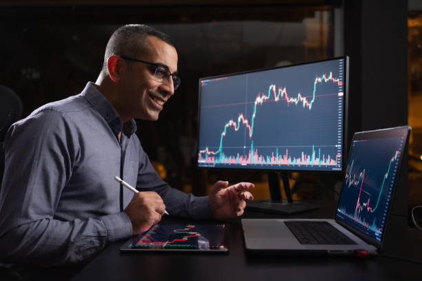 istock Man Checking His Stock Market Exchange Investment Using His Laptop Computer At Night. 1718651096
