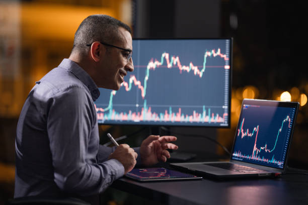 istock Man Checking His Stock Market Exchange Investment Using His Laptop Computer At Night. 1718653804