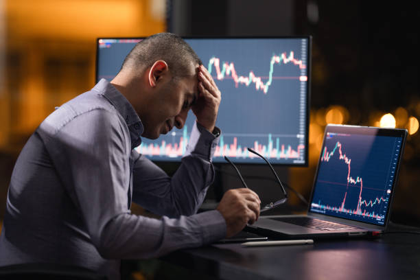 istock Tired Man Checking His Stock Market Exchange Investment Using His Laptop Computer At Night. 1718656042
