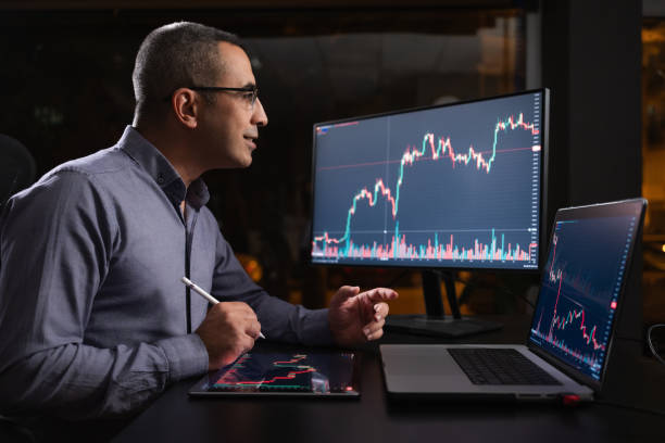 istock Man Checking His Stock Market Exchange Investment Using His Laptop Computer At Night. 1718656260