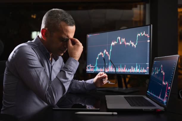 istock Tired Man Checking His Stock Market Exchange Investment Using His Laptop Computer At Night. 1718657902