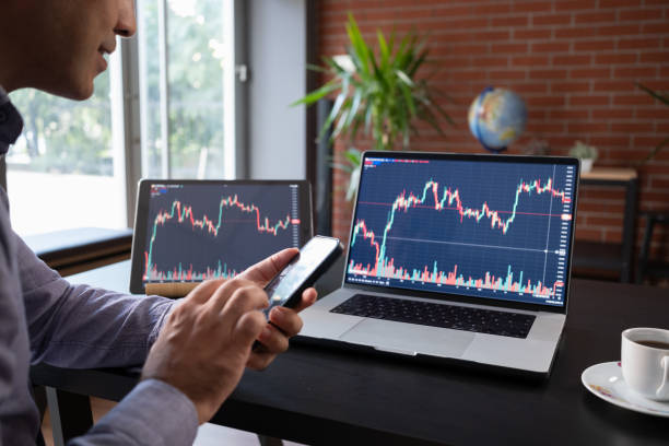 istock Man Checking His Stock Market Exchange Investment Using His Laptop Computer. 1718658458