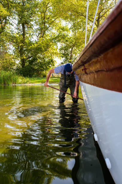 istock A skipper cleans the underwater hull of his sailboat from algae with a scrubber 1718660672