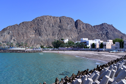 Kalbooh / Kalbuh, Old Muscat, Oman: ancient fishing village with a pleasant beach on a bay under the dramatic scarps of the Al Hajar mountains - located after Riyam, at the entrance to Old Muscat. Al Bahri road with dolos tetrapods protecting the coast.
