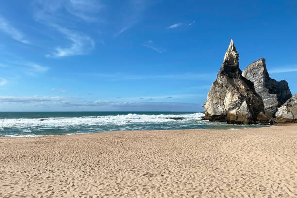 istock Empty wild sandy beach, Atlantic Ocean seascape, sea waves, beautiful cloudscape, dramatic landscape, travel content, Lisbon, Portugal 1718678058