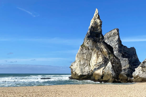 istock Empty wild sandy beach, Atlantic Ocean seascape, sea waves, beautiful cloudscape, dramatic landscape, travel content, Lisbon, Portugal 1718678569