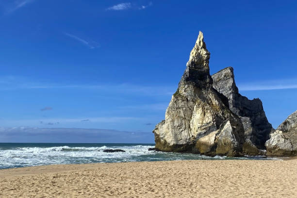 istock Empty wild sandy beach, Atlantic Ocean seascape, sea waves, beautiful cloudscape, dramatic landscape, travel content, Lisbon, Portugal 1718678584