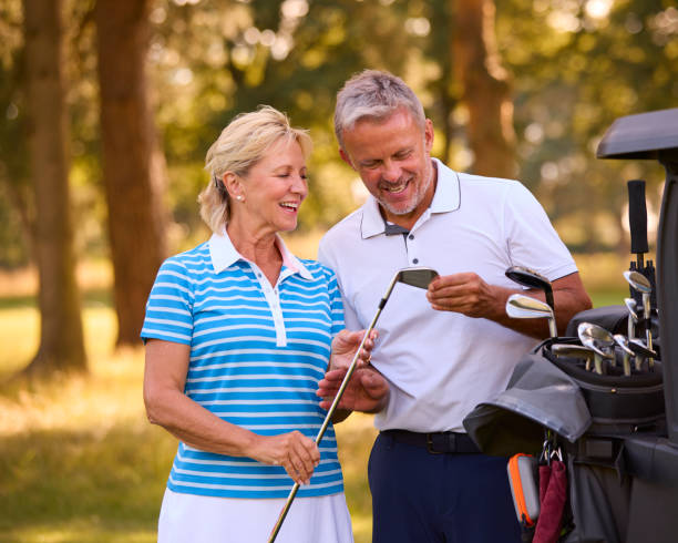 istock Senior Couple Standing Next To Buggy On Golf Course Choosing Clubs Together 1718679143