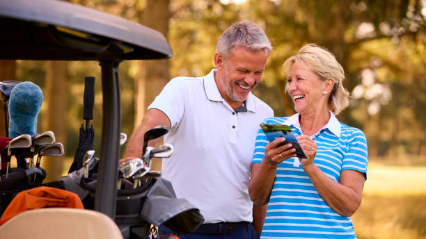 istock Senior Couple Standing Next To Buggy On Golf Course Marking Score Card Together 1718680738