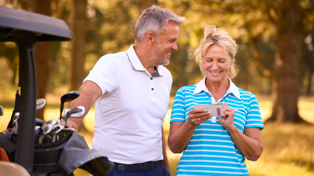 istock Senior Couple Standing Next To Buggy On Golf Course Marking Score Card Together 1718681827