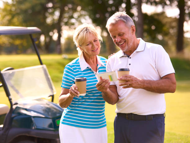 istock Senior Couple With Buggy On Golf Course Marking Score Card Together 1718683967