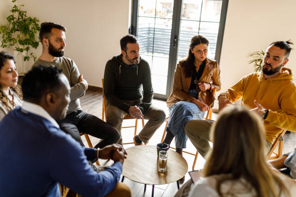 istock Diverse group of people discussing emotions and feeling during a therapy session 1718686656