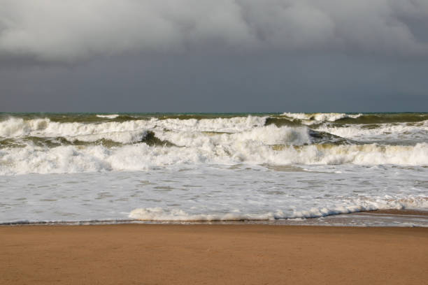 istock Empty wild sandy beach, Atlantic Ocean seascape, sea waves, beautiful cloudscape, dramatic landscape, travel content, Lisbon, Portugal 1718689069