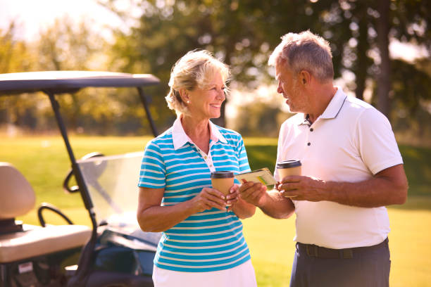 istock Senior Couple With Buggy On Golf Course Marking Score Card Together 1718689172