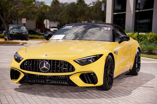 Fort Lauderdale, FL, USA - October 4, 2023: Stock image of a yellow 2022 Mercedes Benz AMG SL Roadster Roadster