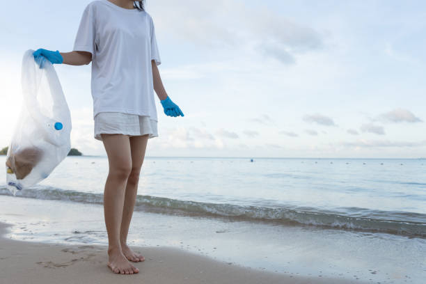 istock Save water. Volunteer pick up trash garbage at the beach and plastic bottles are difficult decompose prevent harm aquatic life. Earth, Environment, Greening planet, reduce global warming, Save world 1718696707