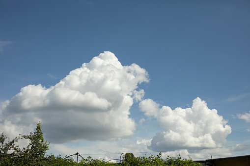 Large white clouds in summer. Cumulus clouds and blue skies. Summer weather.