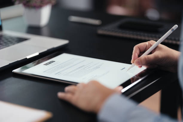 istock Businesswoman signing digital contract on tablet 1718708647