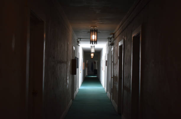 An eerie, desolate hotel corridor, devoid of any signs of life, shrouded in a dim, unsettling atmosphere.