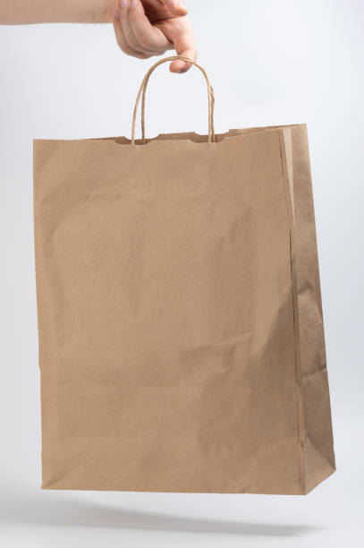 istock Brown paper bag in hand 1718713982