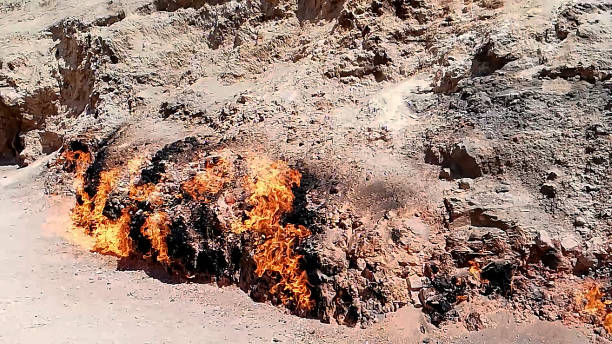 Natural Gas Fire on Mountainside, Yanar Dag in Baku Azerbaijan. Yanar Dag is a natural gas fire which blazes continuously on a hillside near Baku City. baku national park stock pictures, royalty-free photos & images