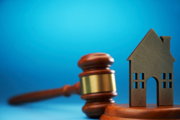 istock gavel hammer and model house against blue background 1718720610