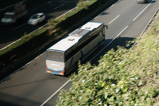 Rear view of a coach bus in motion on a highway