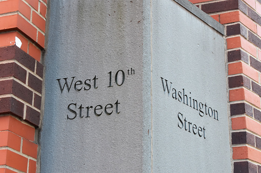A street sign at the intersection of West 10th Street and Washington Street in New York City, highlighting the city's urban landscape and providing road direction in the Manhattan borough of NYC, NY, USA.