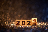 Wooden New Year 2024 on defocused lights - Background Party Celebration Christmas Gold
