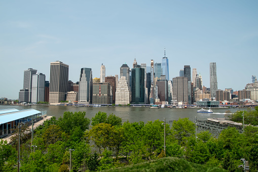 A breathtaking view of Manhattan's iconic skyscrapers, showcasing the modern architectural marvels of New York City, as seen from the water's edge.