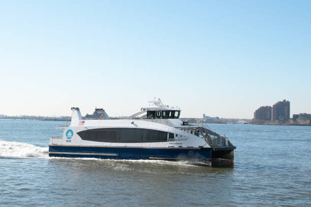 New York City ferry in the Financial District, Manhattan, NYC, NY, USA A New York City ferry docked in the Financial District of Manhattan, surrounded by iconic skyscrapers and the hustle and bustle of downtown NYC. ferry stock pictures, royalty-free photos & images