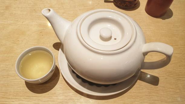 istock a tea pot and a cup of tea on a table 1718773577
