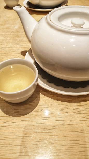 istock a tea pot and a cup of tea on a table 1718773592