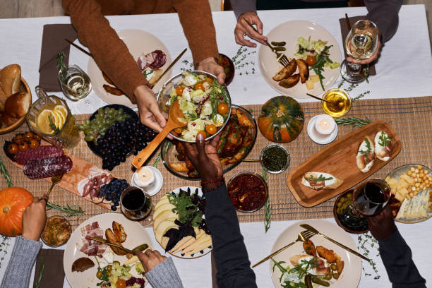 istock Top view people eating at festive dinner table for Thanksgiving 1718782612
