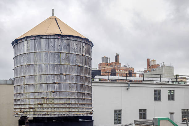 West 25th Street, Manhattan, New York, USA - August 17th 2023:  One of the famous wooden water tanks on a roof on a cloudy day