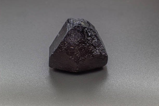 istock Macro focused black tourmaline schrol crystal isolated on gray background 1718805035