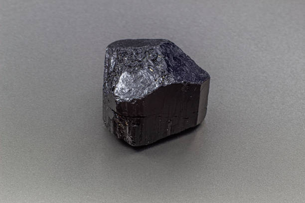 istock Macro focused black tourmaline schrol crystal isolated on gray background 1718805038
