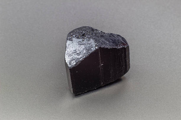 istock Macro focused black tourmaline schrol crystal isolated on gray background 1718805039