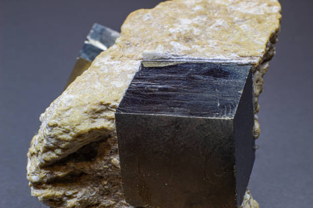 istock Macro cubical pyrite on white matrix isolated on gray background 1718805582